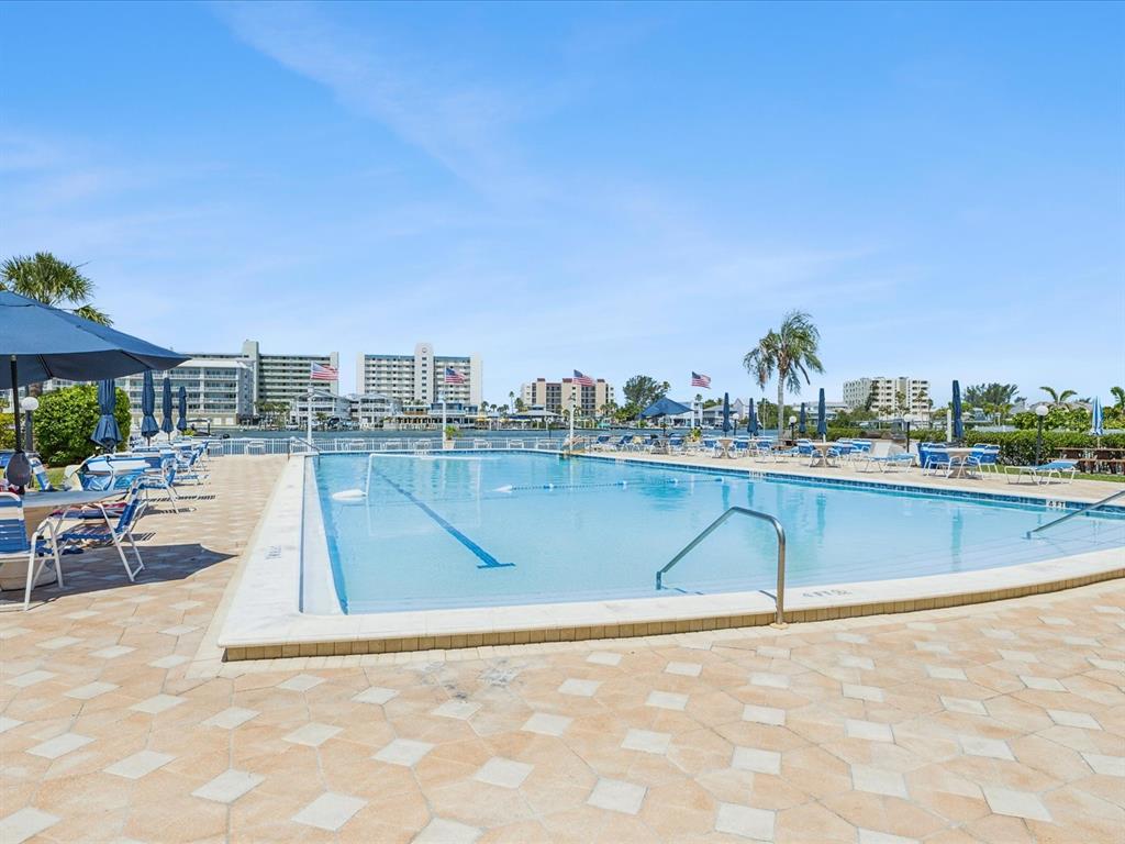 10216 Regal Drive, Unit 409 Largo, FL 33774 - Photo 30 of 42 a view of swimming pool with outdoor seating and city view