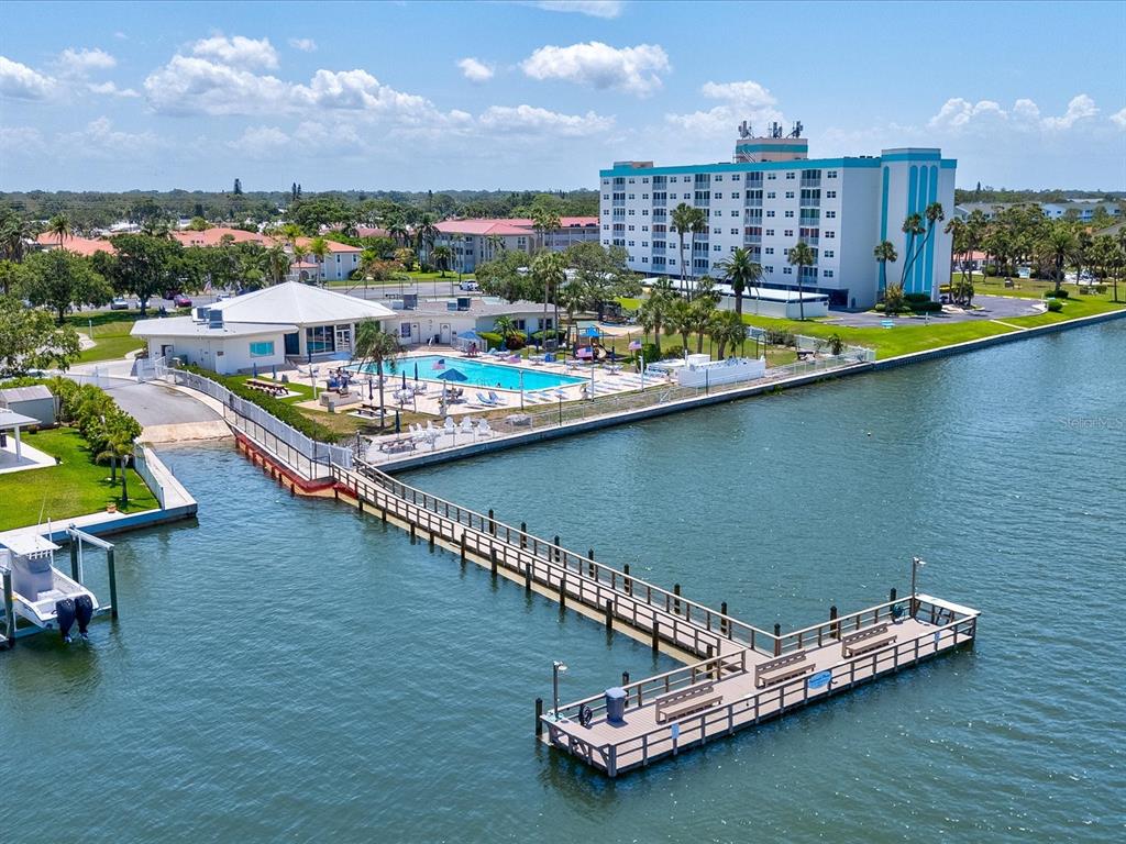 10216 Regal Drive, Unit 409 Largo, FL 33774 - Photo 32 of 42 a view of a lake with a nearby beach