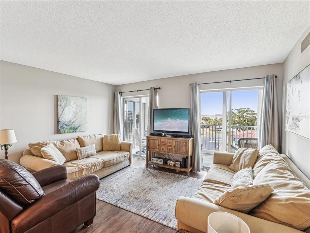 10216 Regal Drive, Unit 409 Largo, FL 33774 - Photo 5 of 42 a living room with furniture window and a flat screen tv