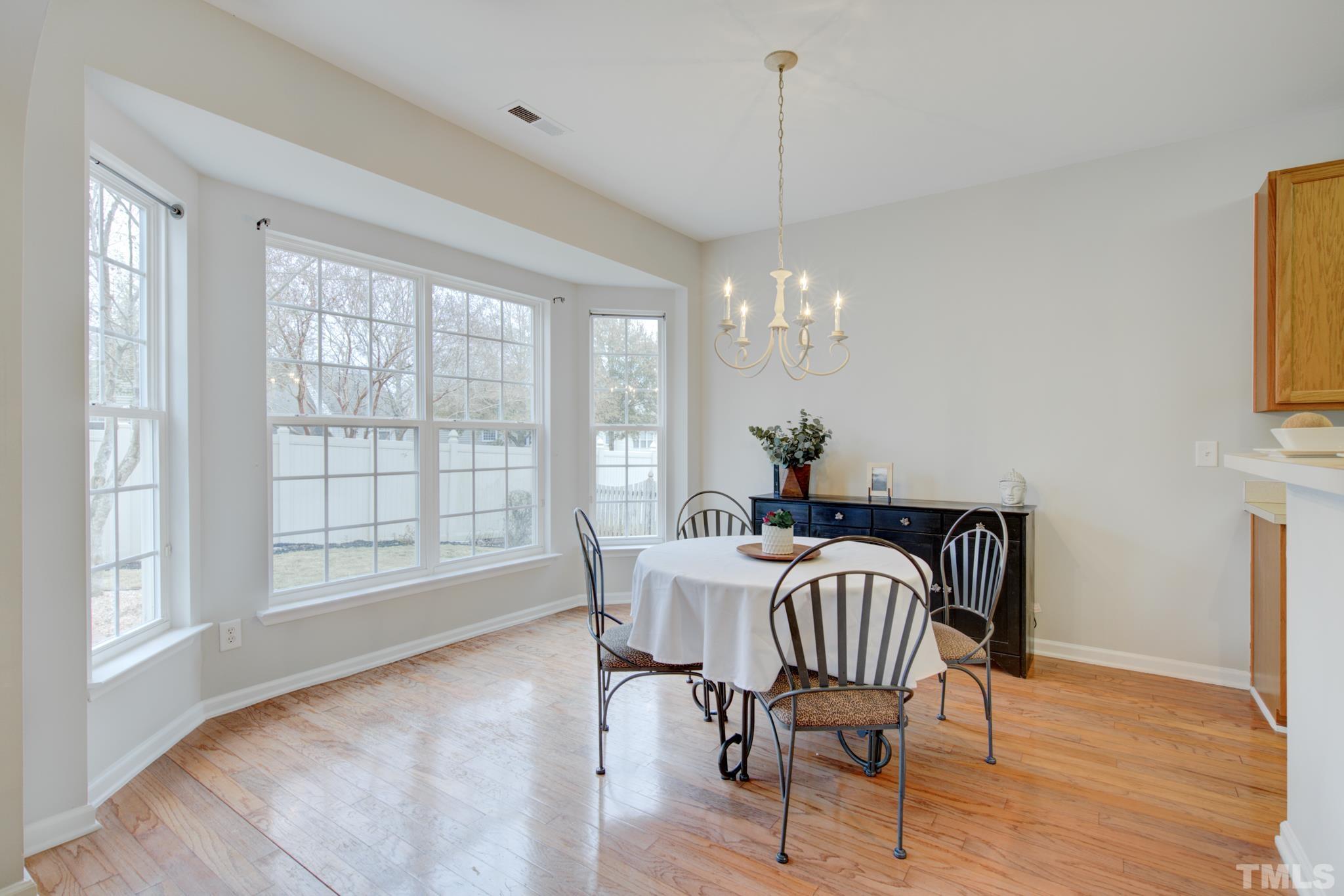8206 Shadow Stone Court Raleigh, NC 27613 - Photo 14 of 52 a view of a dining room with furniture window and wooden floor
