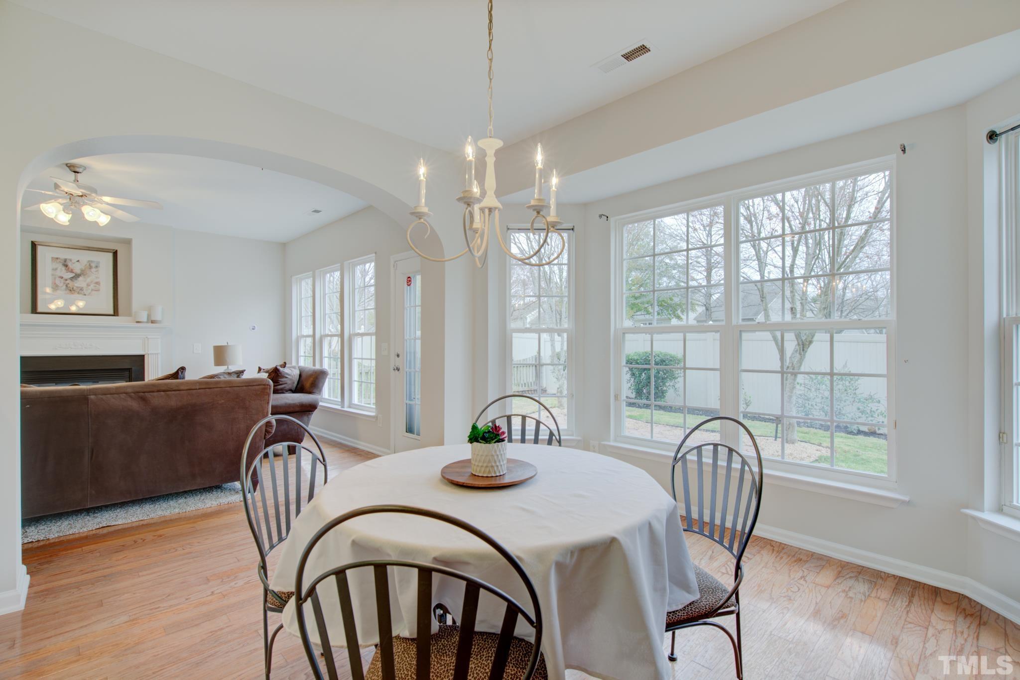 8206 Shadow Stone Court Raleigh, NC 27613 - Photo 16 of 52 a view of a a dining room with furniture window and wooden floor