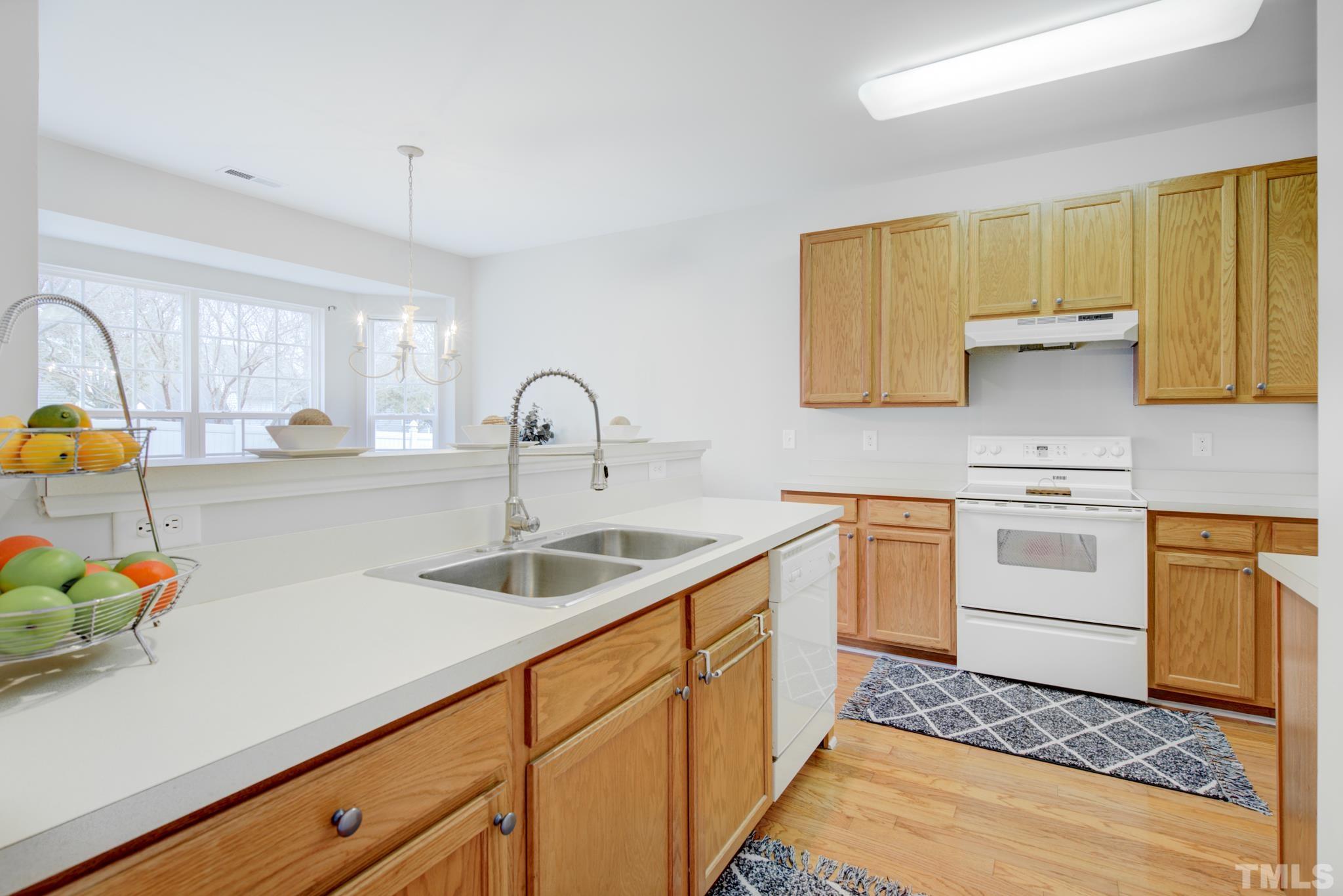 8206 Shadow Stone Court Raleigh, NC 27613 - Photo 20 of 52 a kitchen with a sink stove and cabinets
