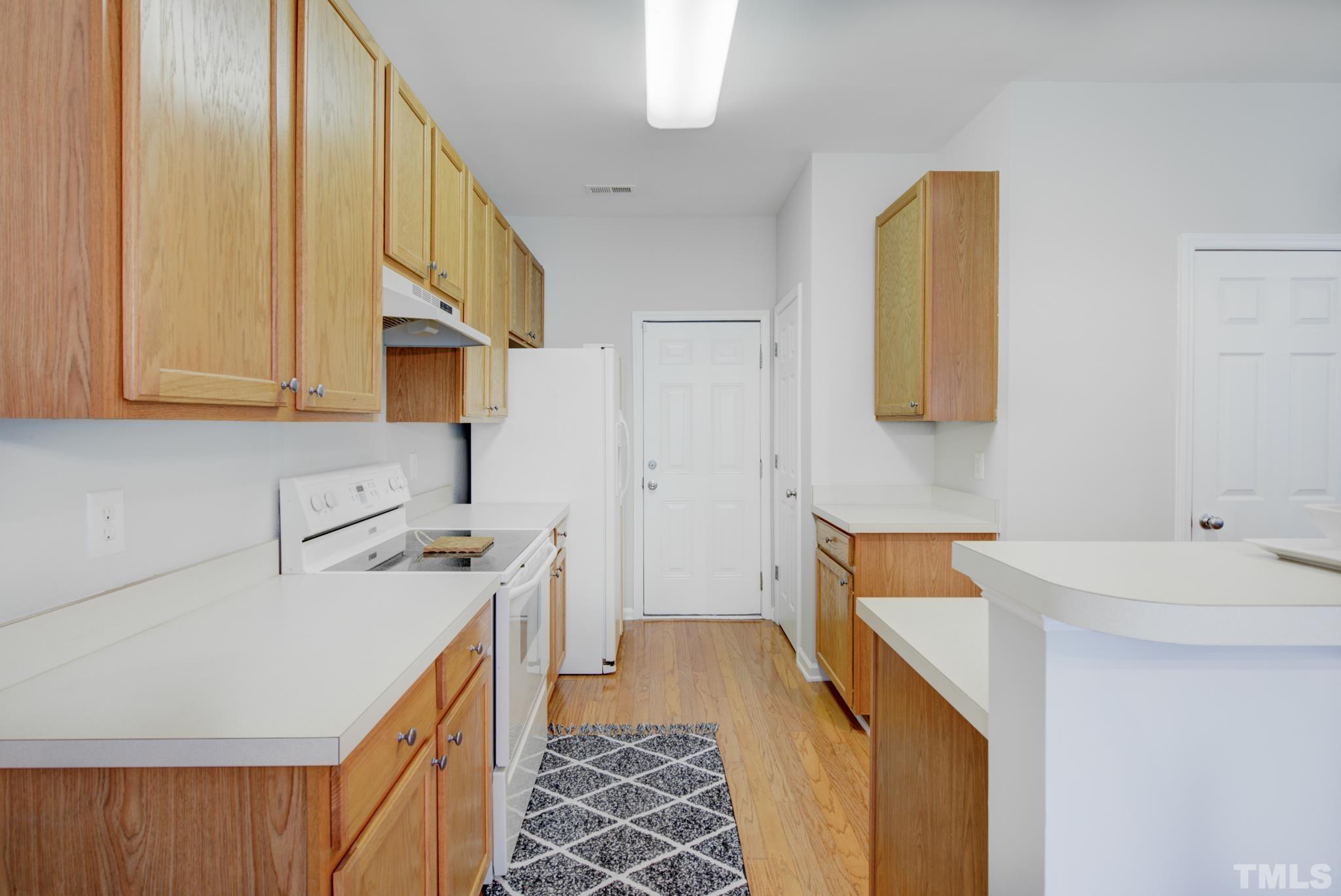 8206 Shadow Stone Court Raleigh, NC 27613 - Photo 22 of 52 a kitchen with a sink a stove and a refrigerator