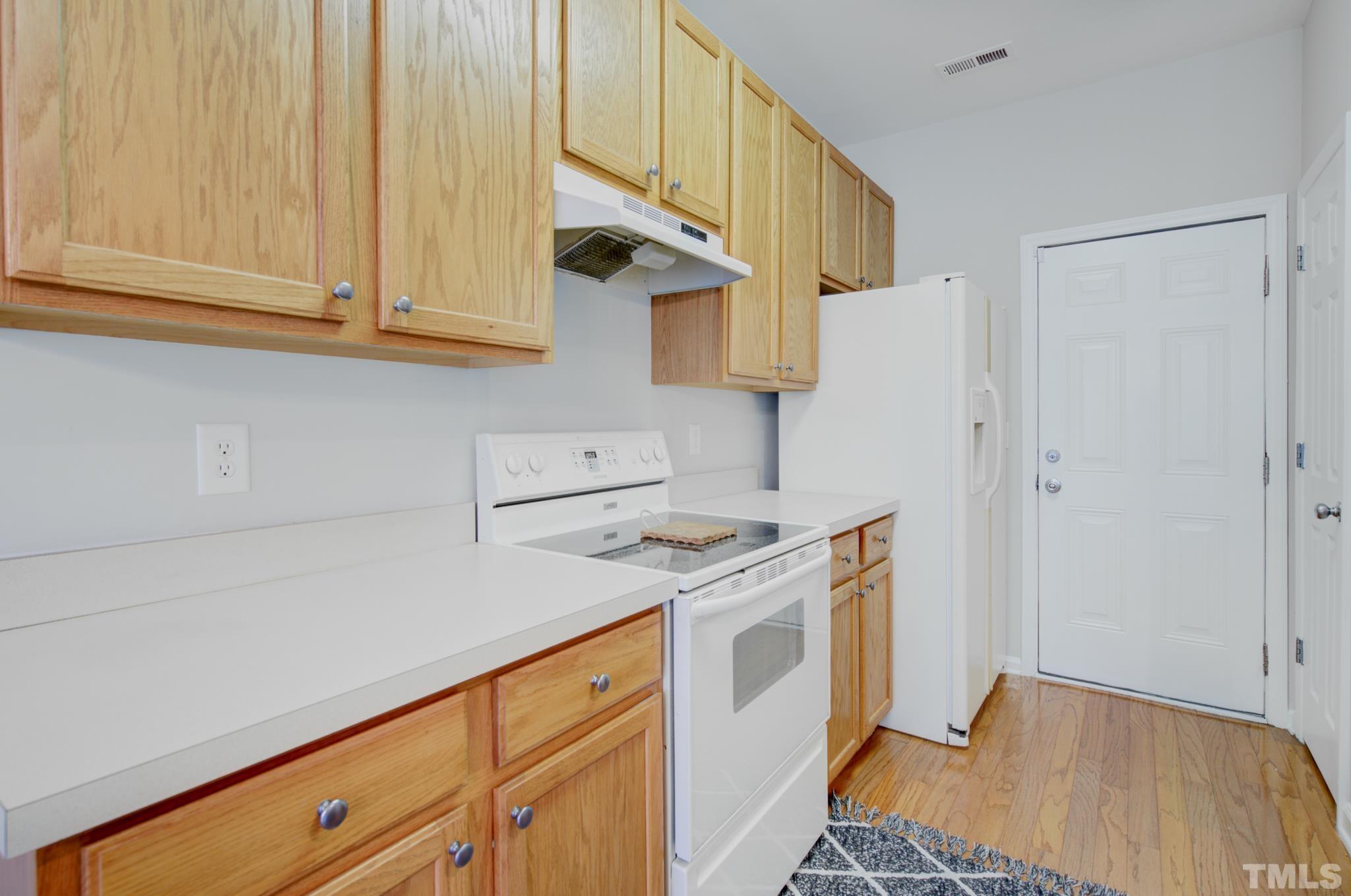 8206 Shadow Stone Court Raleigh, NC 27613 - Photo 23 of 52 a kitchen with stainless steel appliances granite countertop a sink a stove and a refrigerator