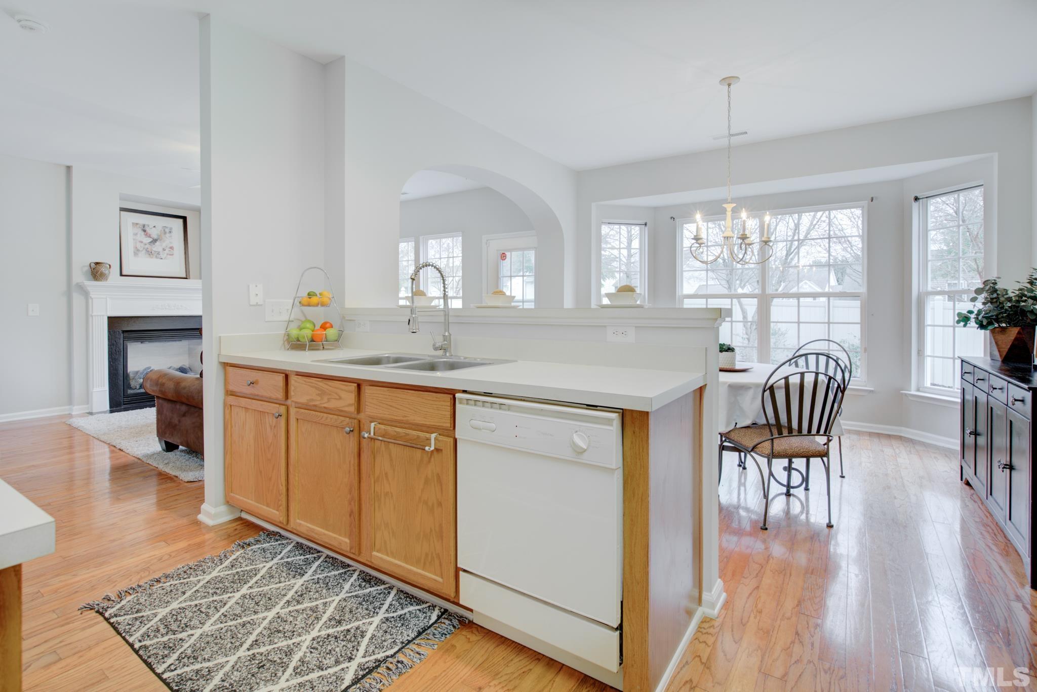 8206 Shadow Stone Court Raleigh, NC 27613 - Photo 24 of 52 a kitchen with granite countertop a stove a sink a dining table and chairs