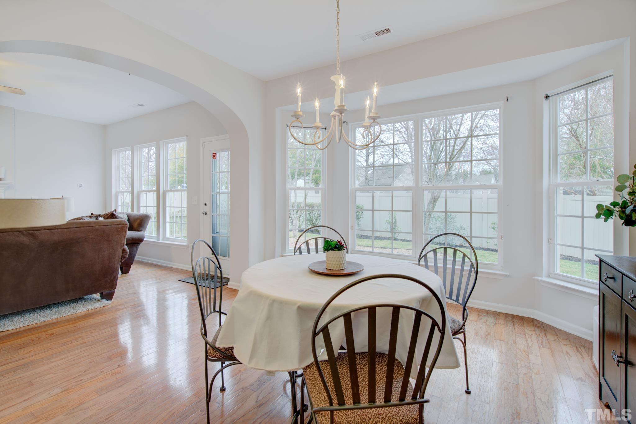 8206 Shadow Stone Court Raleigh, NC 27613 - Photo 25 of 52 a view of a a dining room with furniture window and wooden floor