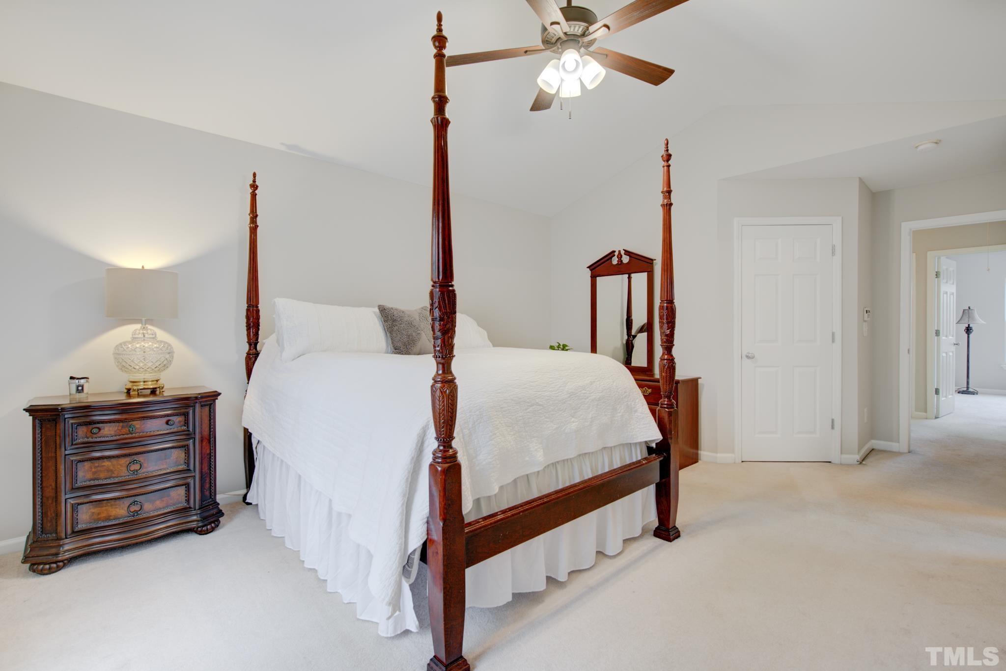 8206 Shadow Stone Court Raleigh, NC 27613 - Photo 29 of 52 a bed room with a bed and a chandelier