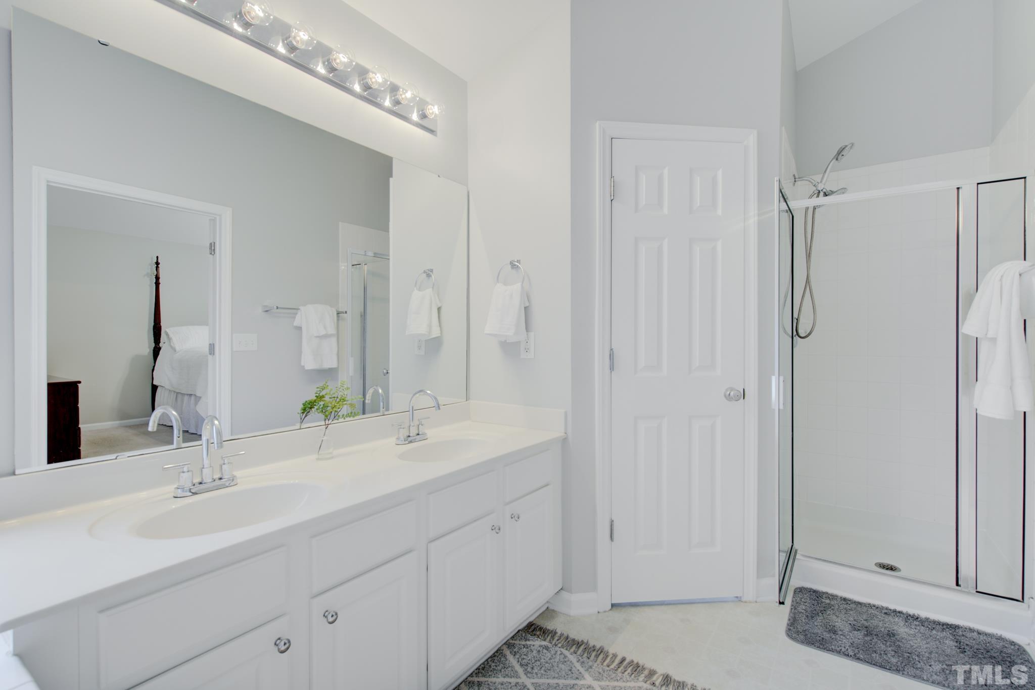 8206 Shadow Stone Court Raleigh, NC 27613 - Photo 33 of 52 a bathroom with double sink and a mirror