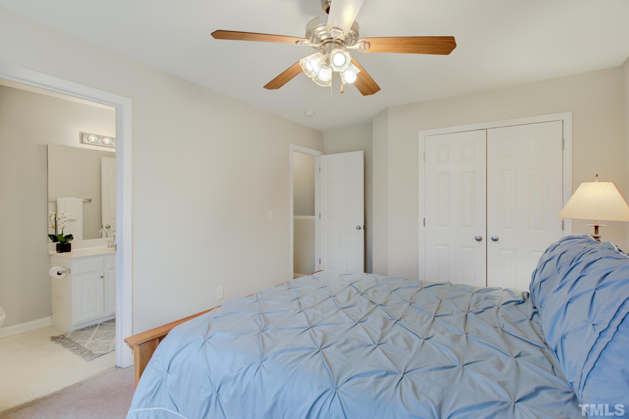 8206 Shadow Stone Court Raleigh, NC 27613 - Photo 38 of 52 a bedroom with a bed and a chandelier