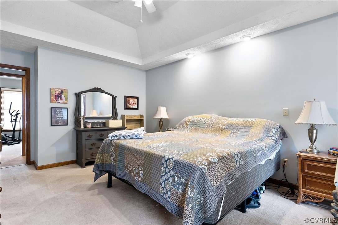 2631 Colgrave Road Midlothian, VA 23112 - Photo 16 of 23 a bedroom with a bed a mirror on dresser and a chandelier