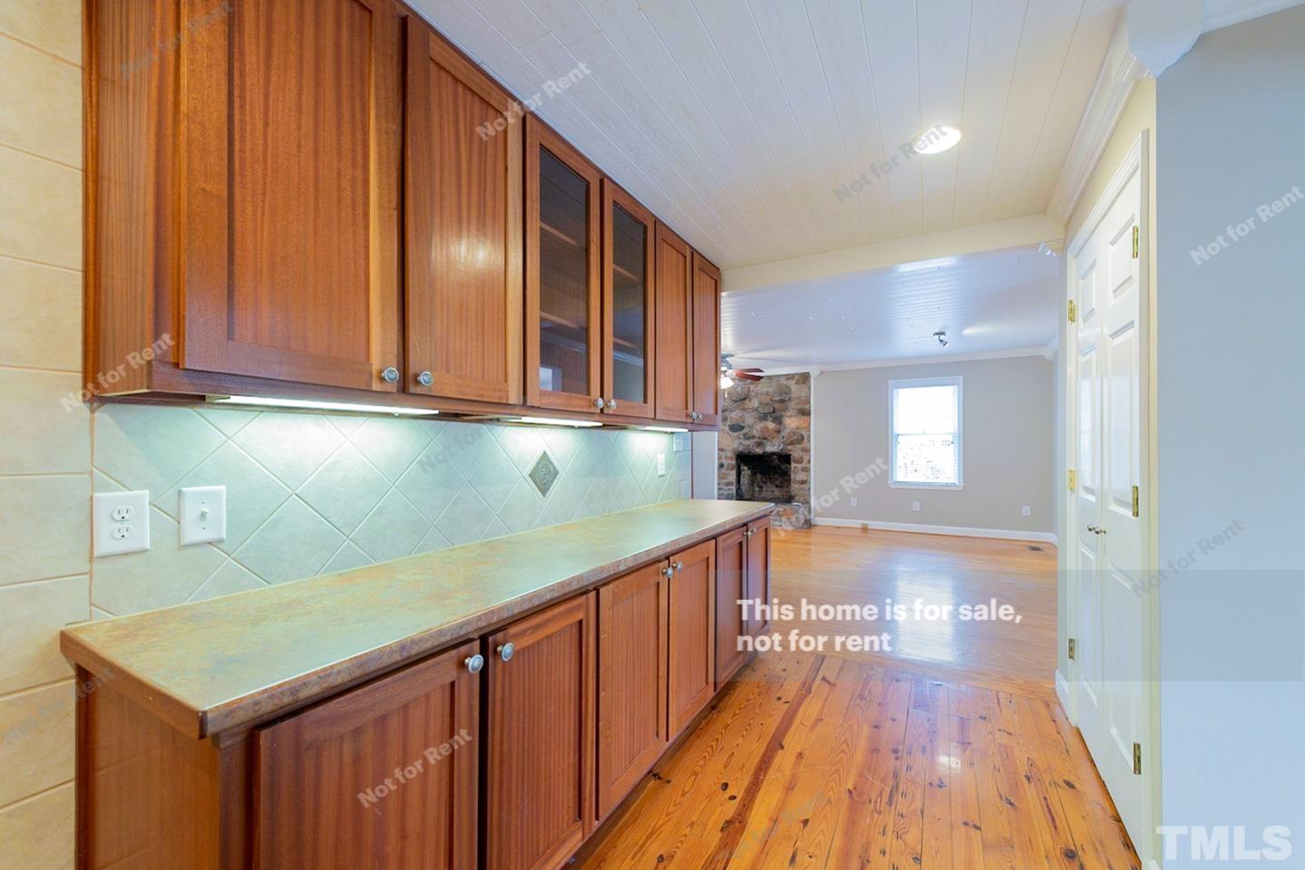 12008 Shooting Club Road Raleigh, NC 27613 - Photo 11 of 23 a view of a kitchen with wooden floor and staircase