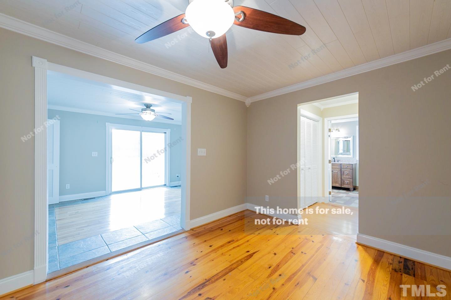 12008 Shooting Club Road Raleigh, NC 27613 - Photo 12 of 23 an empty room with wooden floor and windows