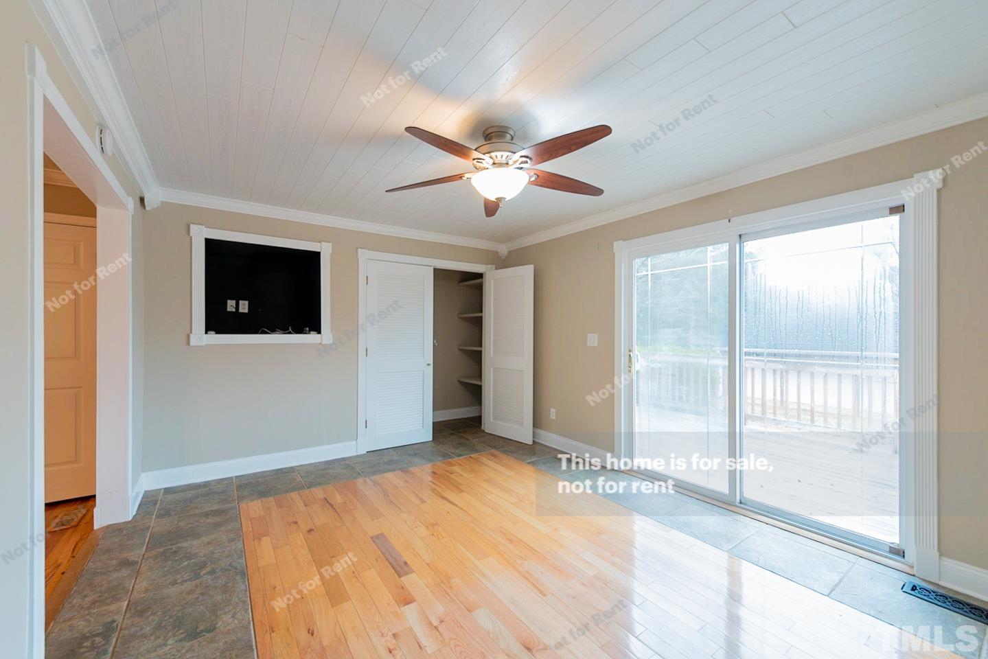 12008 Shooting Club Road Raleigh, NC 27613 - Photo 13 of 23 a view of a livingroom with a ceiling fan and window