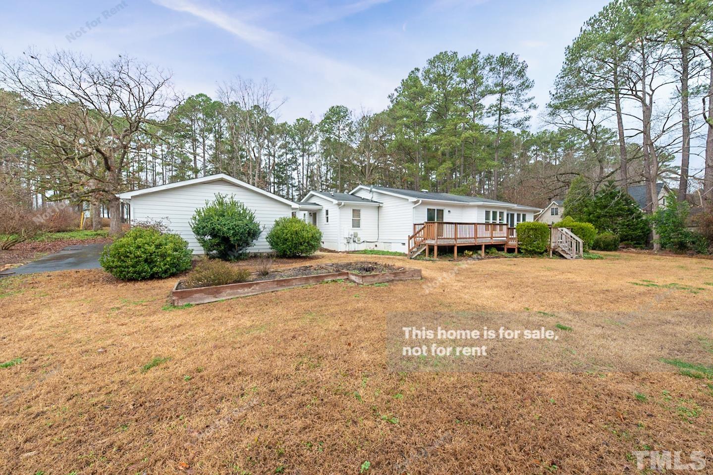 12008 Shooting Club Road Raleigh, NC 27613 - Photo 19 of 23 a house with trees in the background