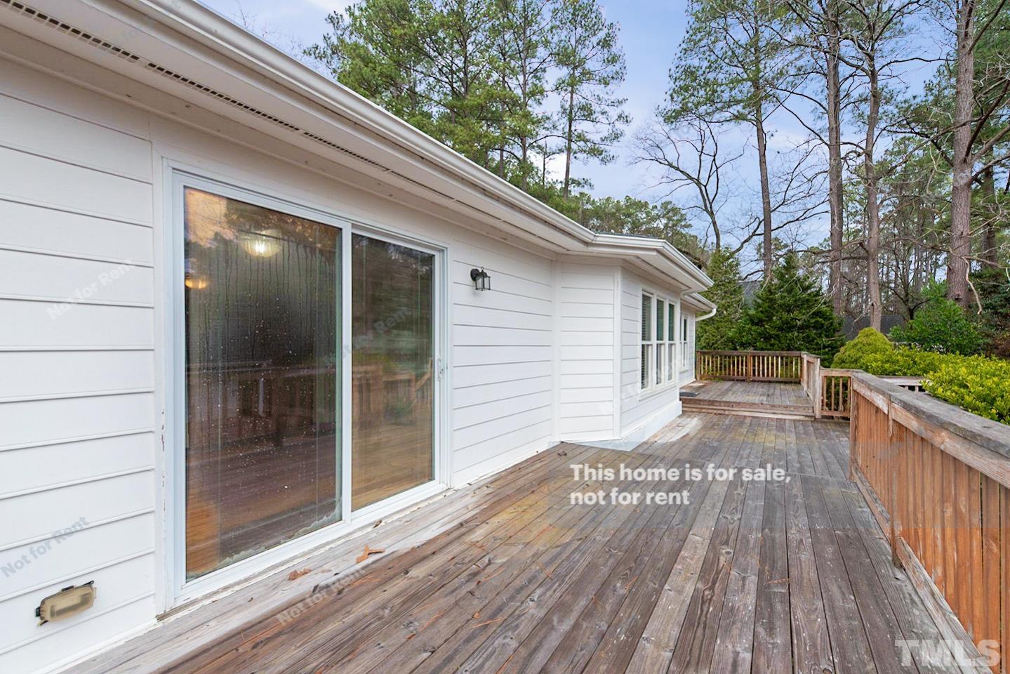12008 Shooting Club Road Raleigh, NC 27613 - Photo 22 of 23 a view of backyard with a deck and wooden floor