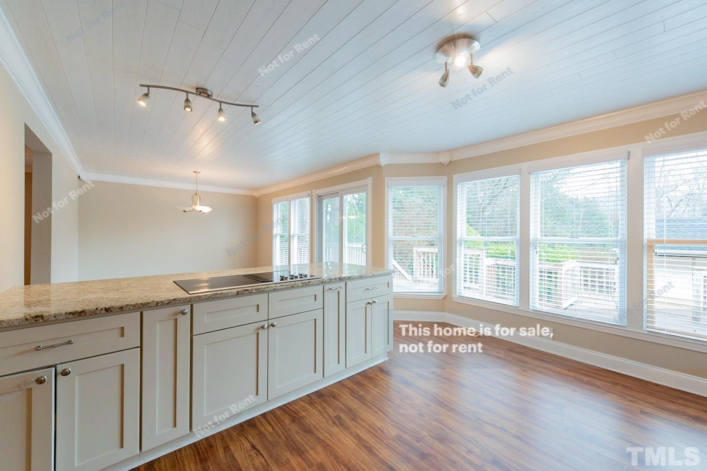 12008 Shooting Club Road Raleigh, NC 27613 - Photo 7 of 23 a large kitchen with a large window and wooden floor
