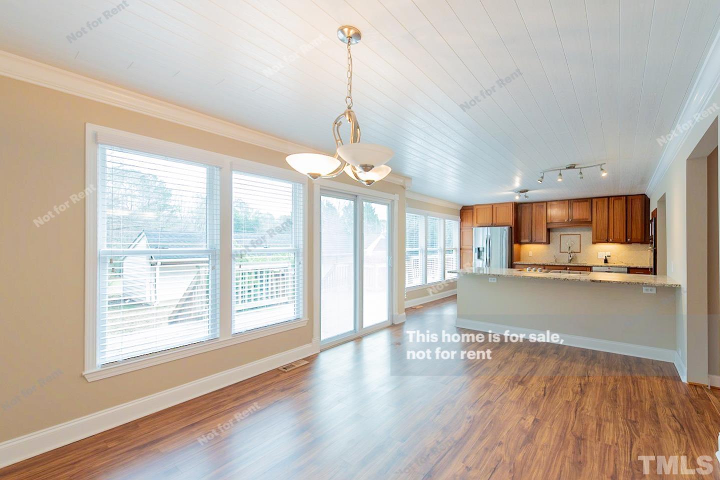 12008 Shooting Club Road Raleigh, NC 27613 - Photo 9 of 23 a view of large kitchen with wooden floor and a large window