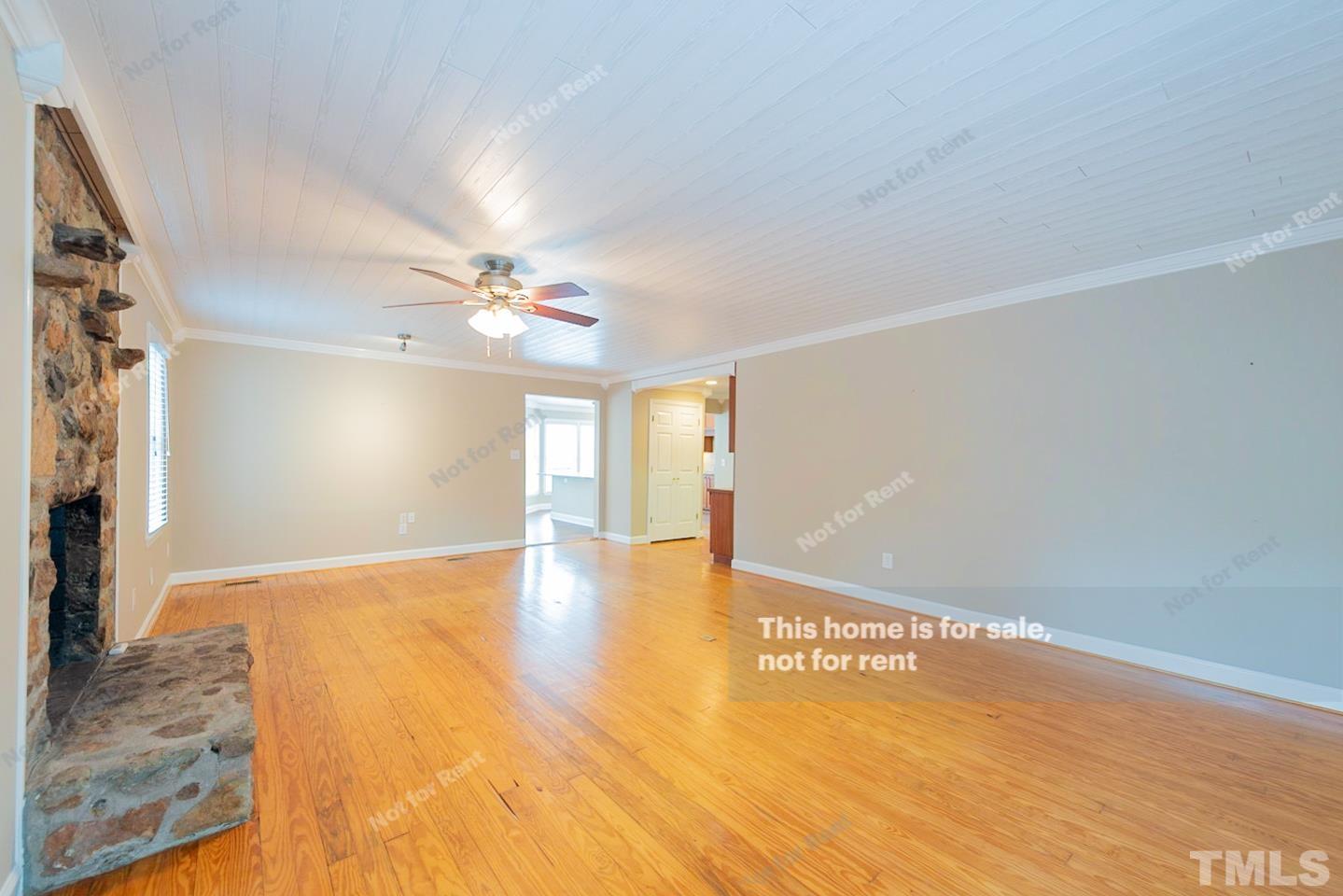 12008 Shooting Club Road Raleigh, NC 27613 - Photo 10 of 23 a view of an empty room with window and wooden floor