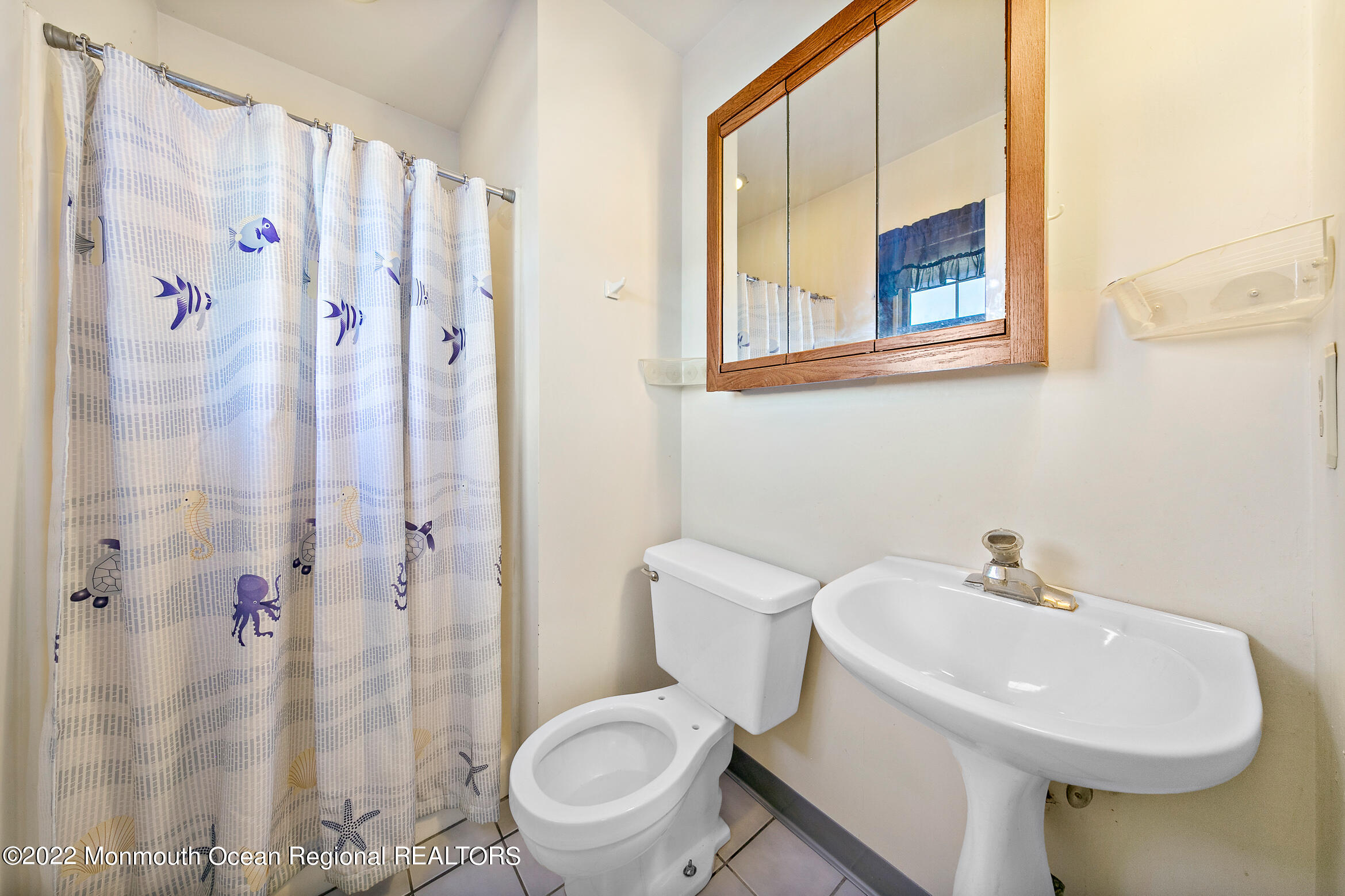69 Horseneck Point Road Oceanport, NJ 07757 - Photo 12 of 22 a white toilet sitting next to a bathroom sink