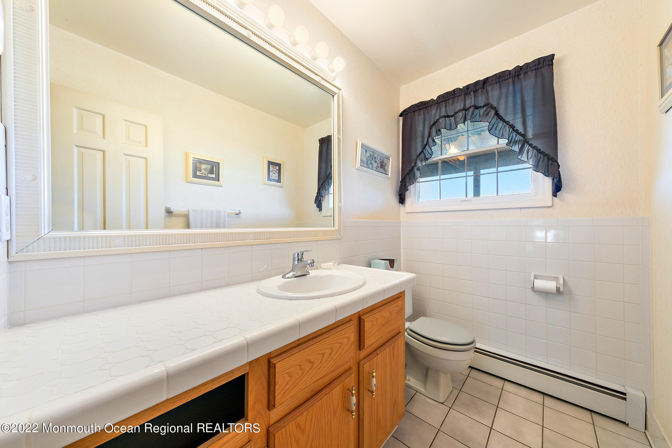 69 Horseneck Point Road Oceanport, NJ 07757 - Photo 13 of 22 a bathroom with a sink mirror vanity and toilet