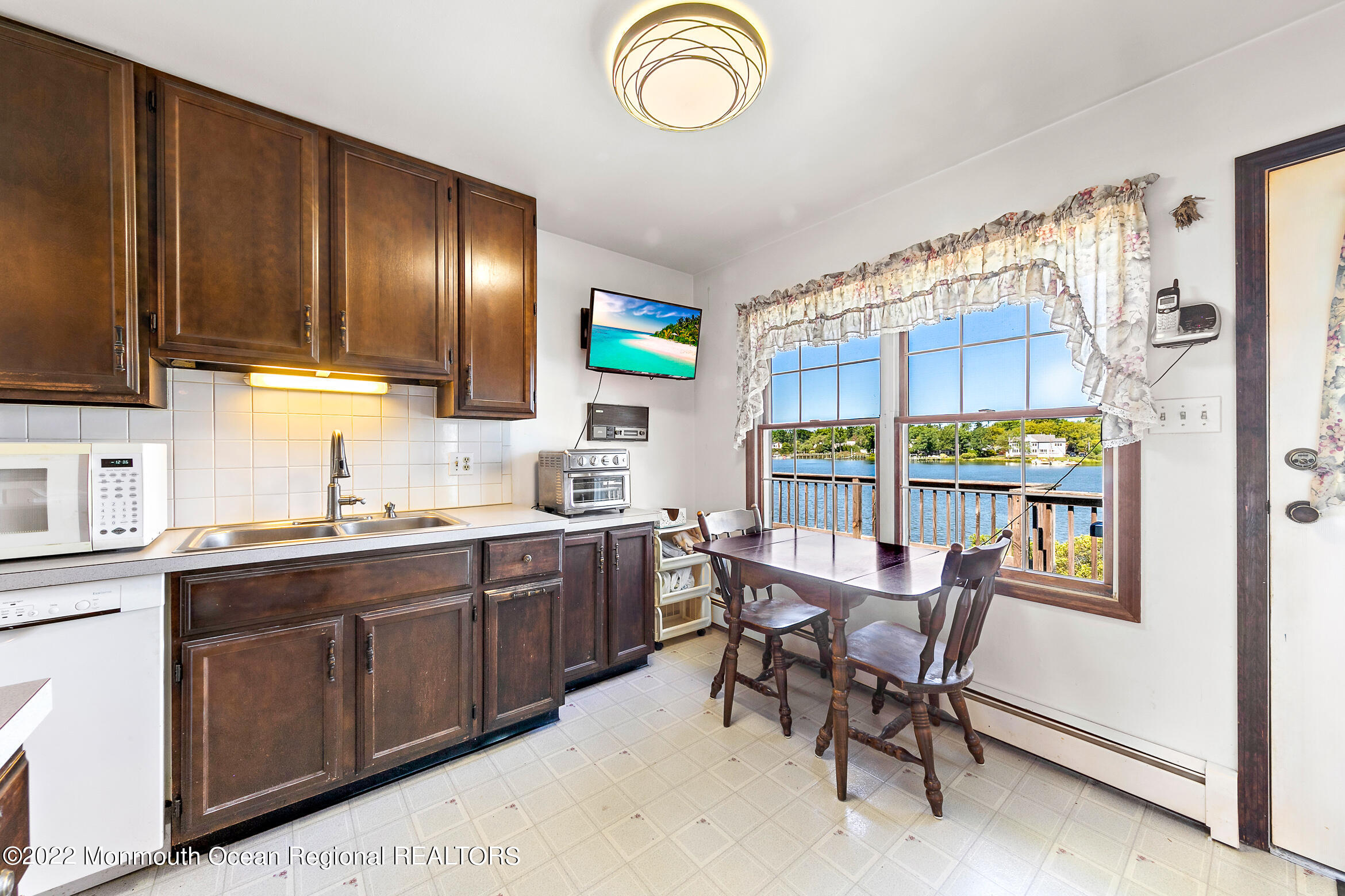 69 Horseneck Point Road Oceanport, NJ 07757 - Photo 5 of 22 a view of a kitchen area with furniture and a window