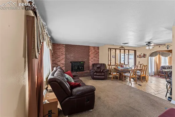 a living room with furniture fireplace and a window