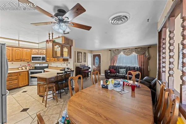 a living room with lots of wooden furniture and a large window