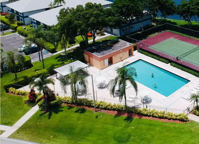an aerial view of residential house with outdoor space and lake view