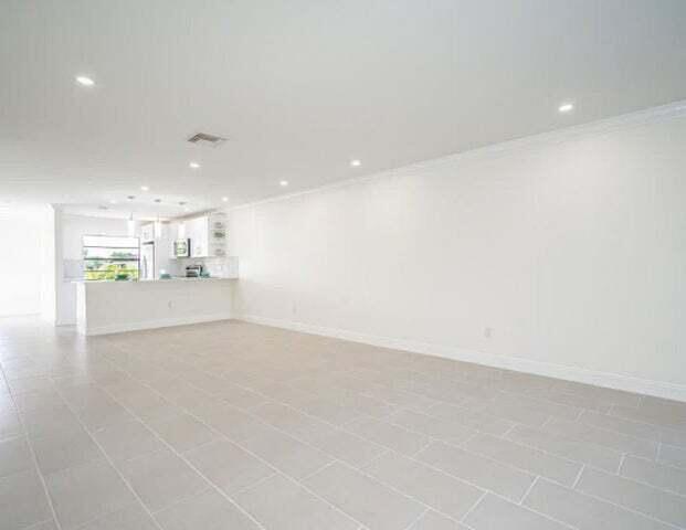 9284 Vista Del Lago, Unit 34F Boca Raton, FL 33428 - Photo 10 of 15 a view of a kitchen with a sink and an oven