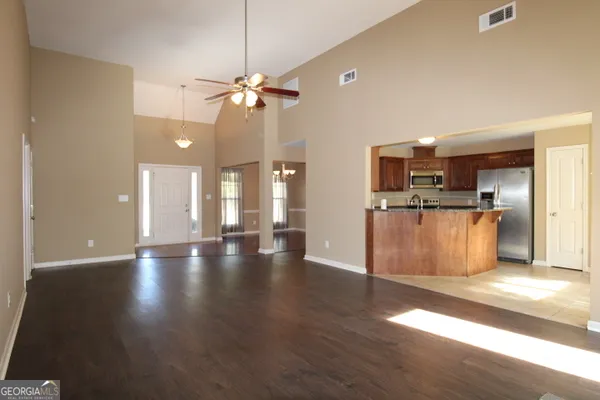 a view of a kitchen with stove and wooden floor
