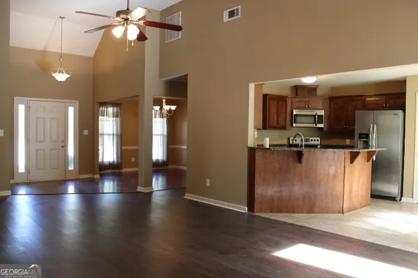 a view of a kitchen with a sink and a refrigerator