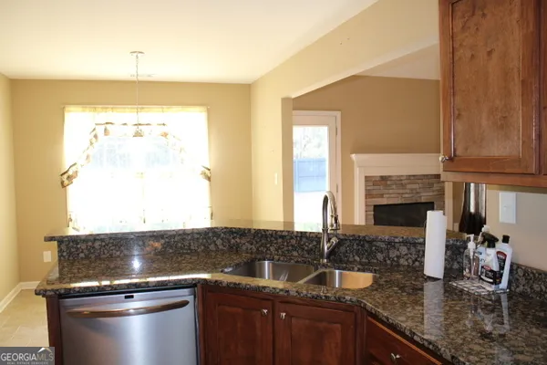 a kitchen with granite countertop a sink and a stove