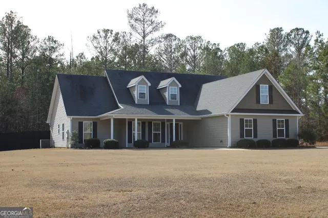 a view of front door and a yard