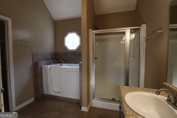 a bathroom with a sink mirror and toilet