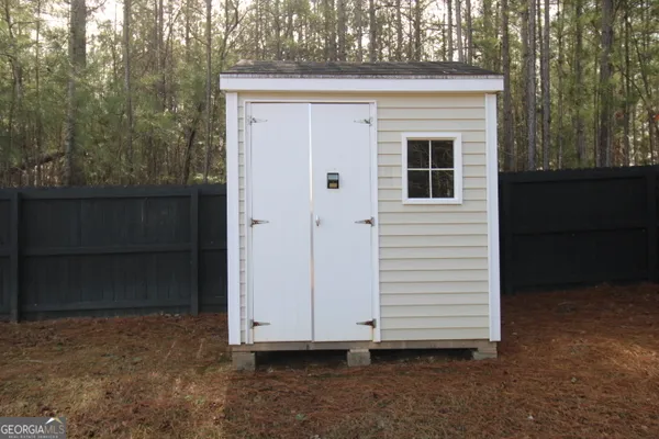 a view of front door and a yard