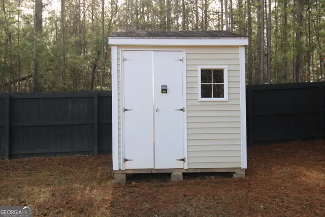 a view of a livingroom with wooden floor and a fireplace