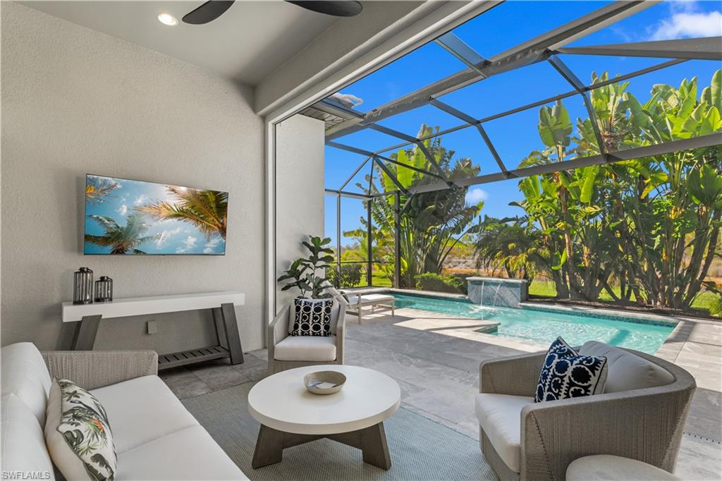 9517 Montelanico Loop Naples, FL 34119 - Photo 11 of 50 a living room with furniture and a potted plant