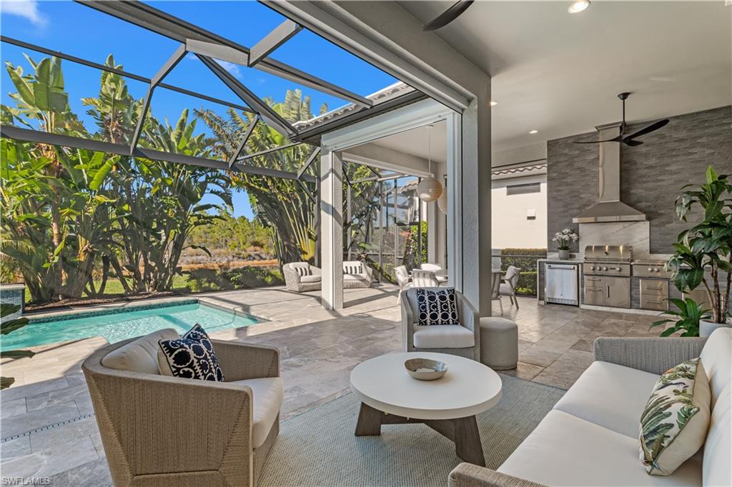 9517 Montelanico Loop Naples, FL 34119 - Photo 12 of 50 a living room with patio furniture and a wooden floor