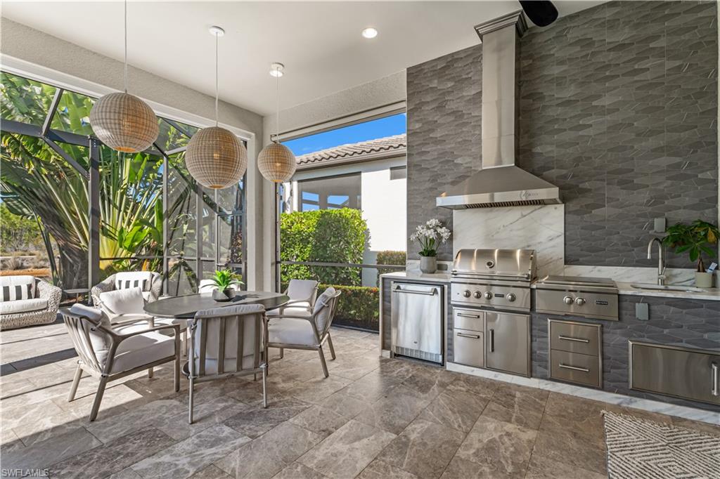 9517 Montelanico Loop Naples, FL 34119 - Photo 13 of 50 a open kitchen with a sink dining table and chairs
