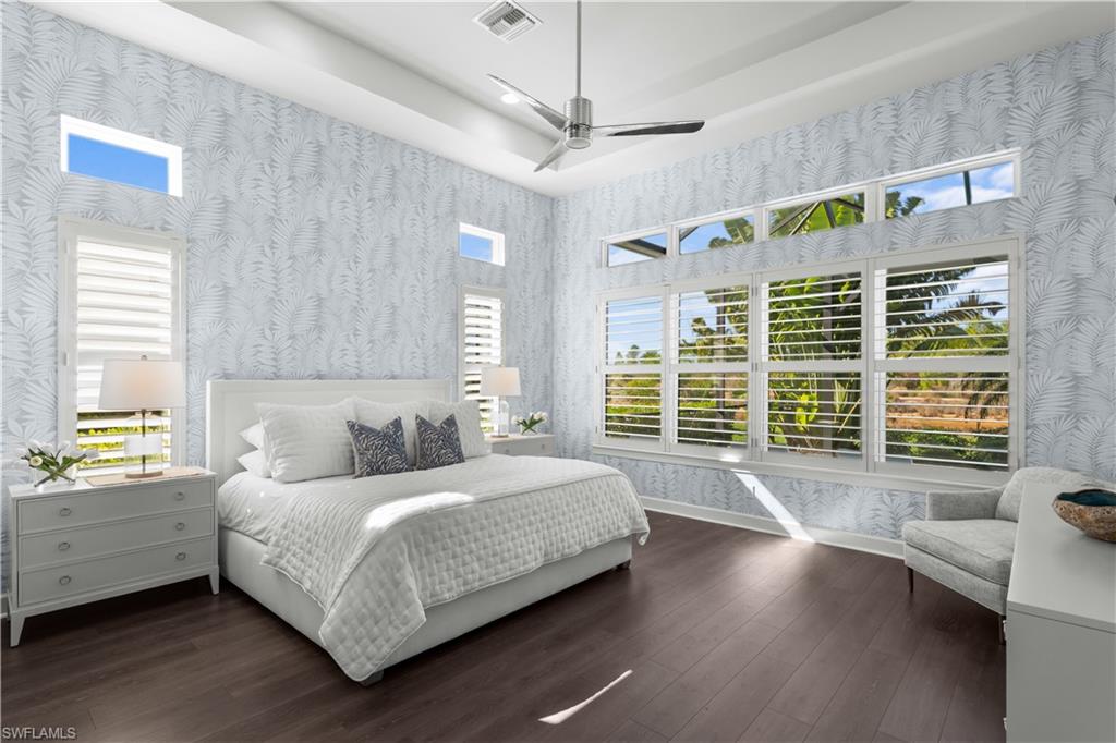 9517 Montelanico Loop Naples, FL 34119 - Photo 16 of 50 a bedroom with a bed and a large window