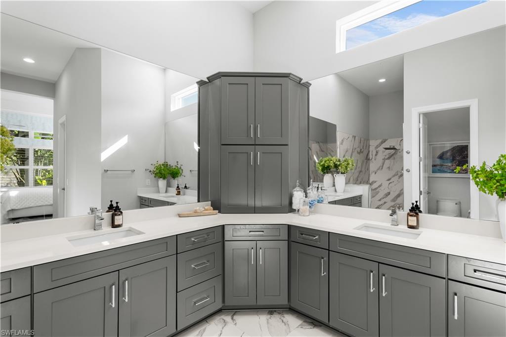 9517 Montelanico Loop Naples, FL 34119 - Photo 18 of 50 a bathroom with a double vanity sink mirror and