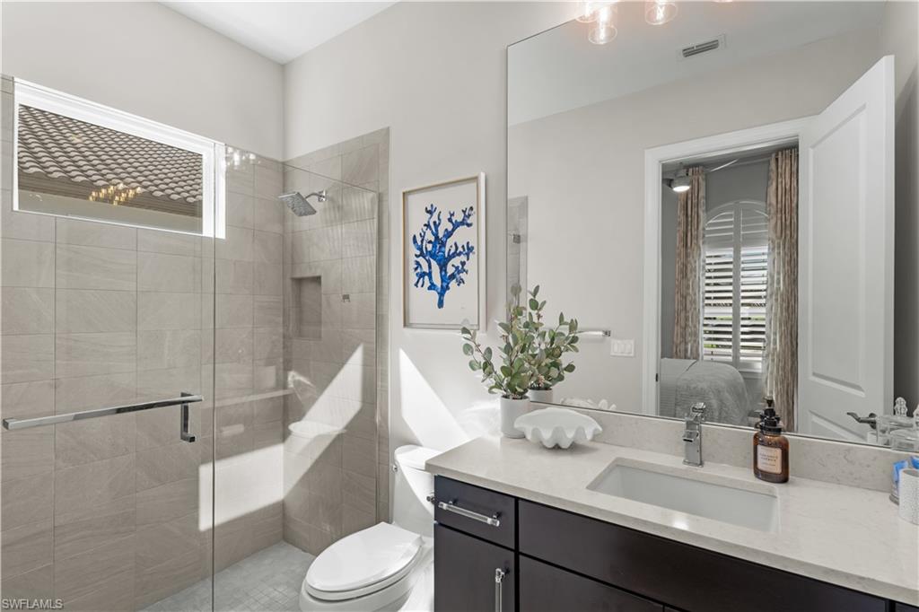 9517 Montelanico Loop Naples, FL 34119 - Photo 21 of 50 a bathroom with a sink toilet and shower