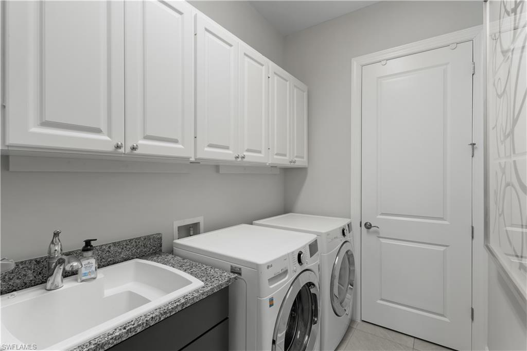 9517 Montelanico Loop Naples, FL 34119 - Photo 26 of 50 a utility room with dryer and washer