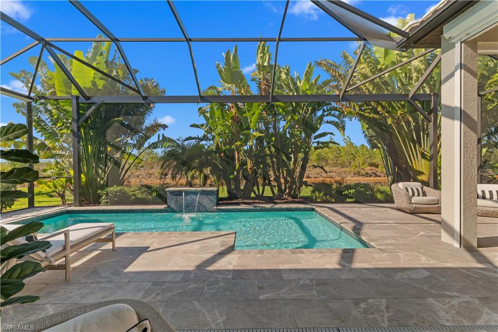 9517 Montelanico Loop Naples, FL 34119 - Photo 30 of 50 a backyard of a house with lots of green space