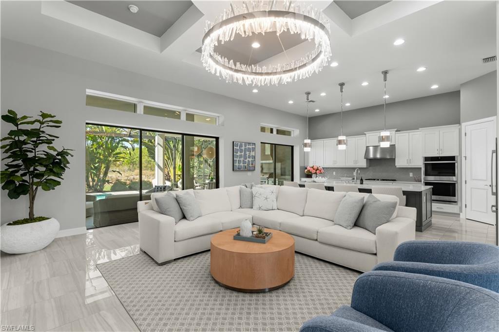 9517 Montelanico Loop Naples, FL 34119 - Photo 3 of 50 a living room with furniture and a large window