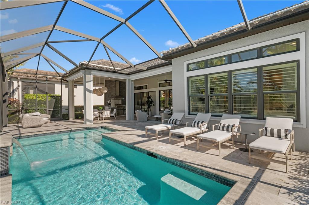 9517 Montelanico Loop Naples, FL 34119 - Photo 32 of 50 a view of a patio with couches table and chairs and potted plants