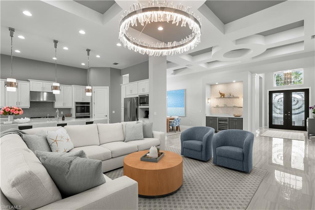 9517 Montelanico Loop Naples, FL 34119 - Photo 4 of 50 a living room with furniture a fireplace and a large window