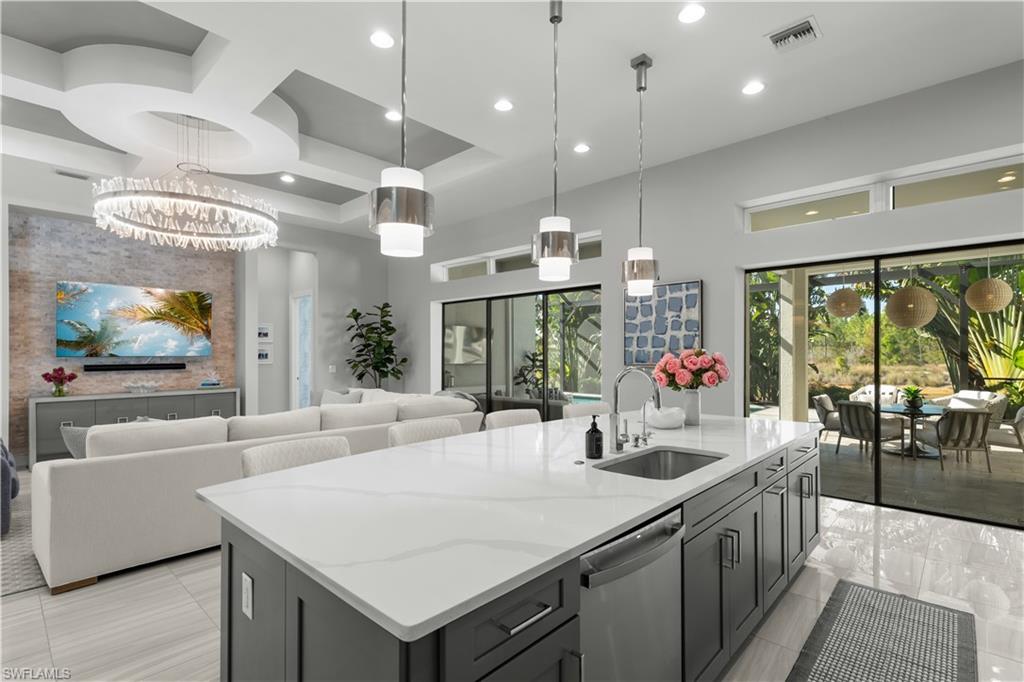 9517 Montelanico Loop Naples, FL 34119 - Photo 10 of 50 a kitchen with stainless steel appliances granite countertop a sink and a large window