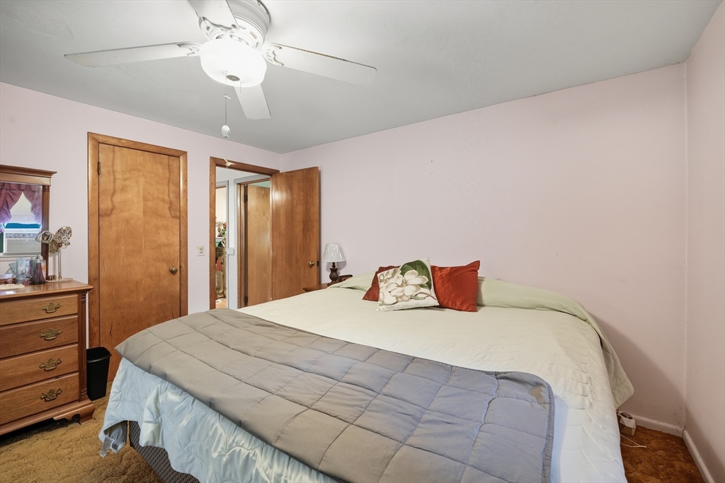 95 Meadowbrook Road Agawam, MA 01001 - Photo 11 of 39 a bedroom with a large bed and a chandelier