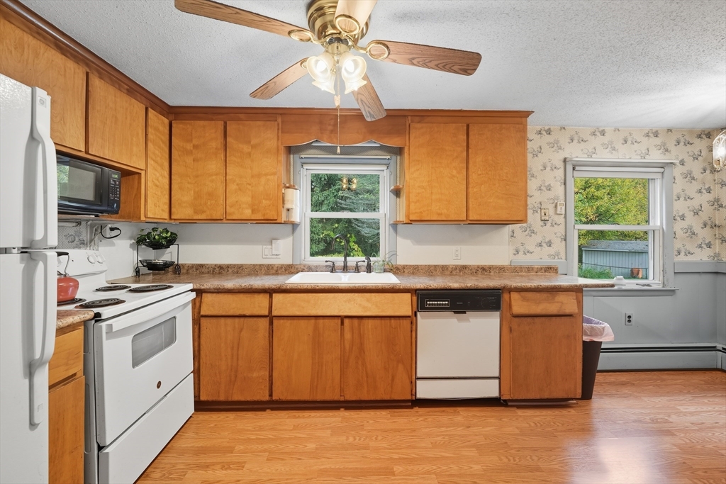 95 Meadowbrook Road Agawam, MA 01001 - Photo 21 of 39 a kitchen with stainless steel appliances granite countertop a stove a sink and a microwave